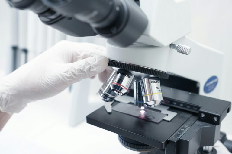 Person studying a slide under a microscope